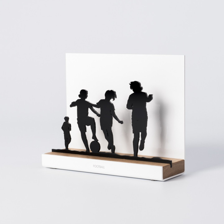 Figure "Football · Children playing together", angled view showing its oak base