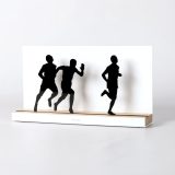 Figure "Athletics · Three runners", angled view showing its oak base