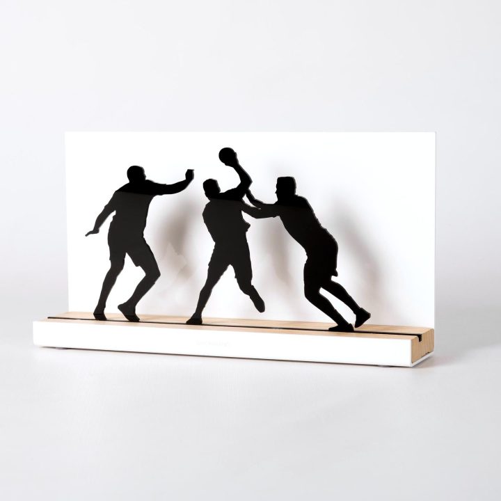 Figure "Handball · Attacker between two defenders", angled view showing its oak base