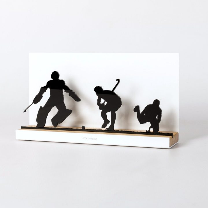 Figure "Field hockey · Goalkeeper and two players", angled view showing its oak base