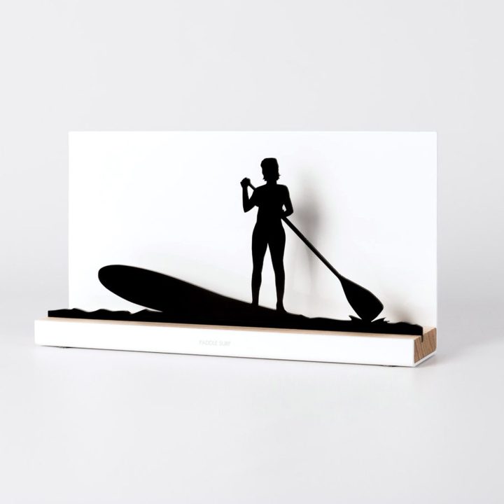 Figure "Paddle surf · Woman paddling upright", angled view showing its oak base