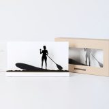 Figure "Paddle surf · Woman paddling upright" next to its sleeve and its gift box