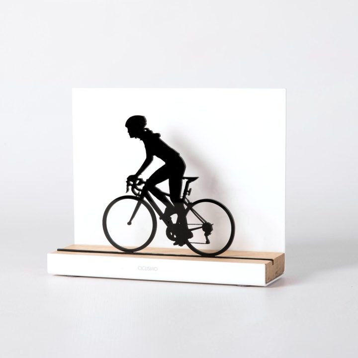 Figure "Cycling · Woman cyclist", angled view showing its oak base