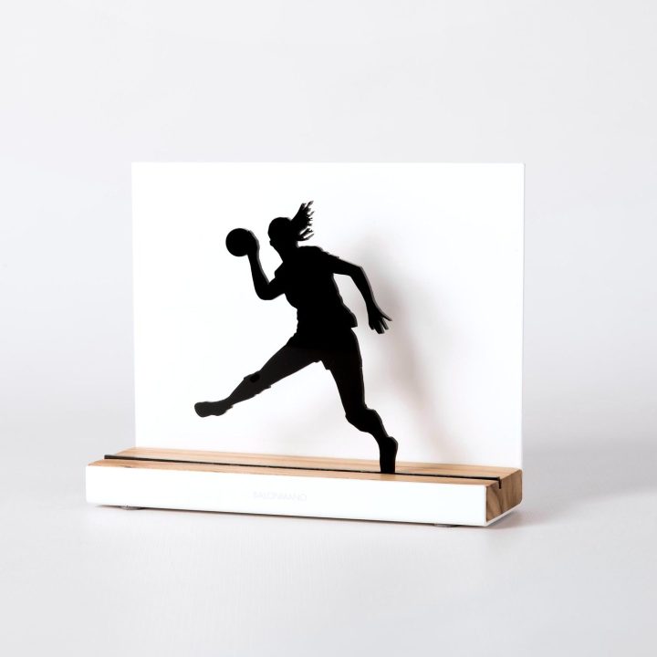 Figure "Handball · Ponytailed player leaping", angled view showing its oak base
