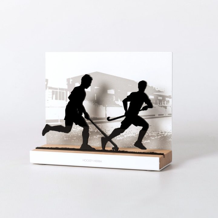Figure "Field hockey · Attack against a defender", angled view showing its oak base