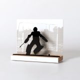 Figure "Field hockey · Goalkeeper making a save", angled view showing its oak base