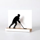 Figure "Ice hockey · Player skating", angled view showing its oak base