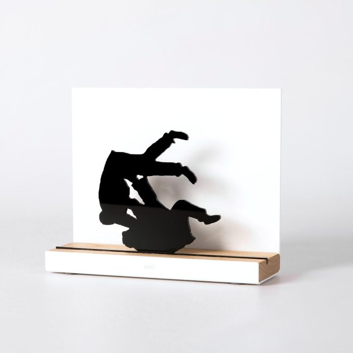 Figure "Judo · Uchi-mata, fall after the throw", angled view showing its oak base