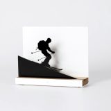 Figure "Skiing · Downhill run", angled view showing its oak base