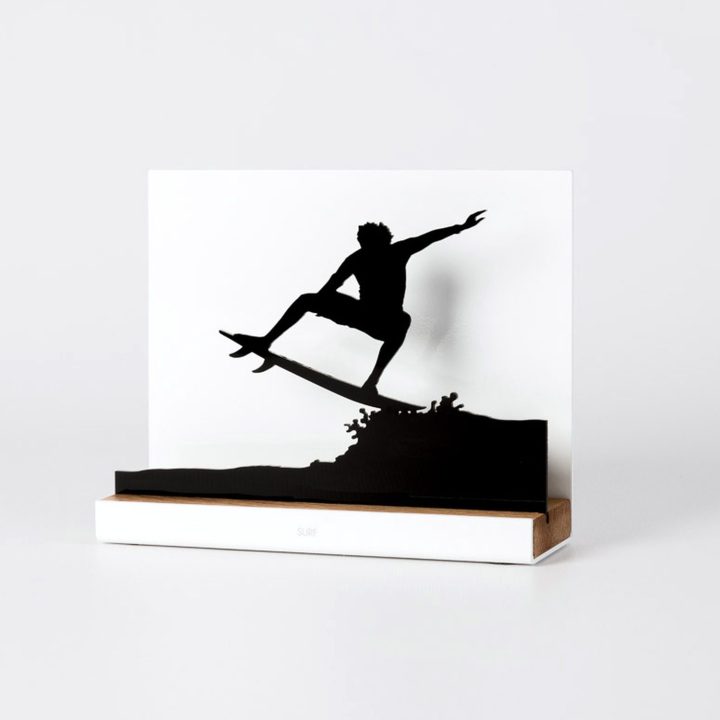 Figure "Surfing · Air reverse", angled view showing its oak base