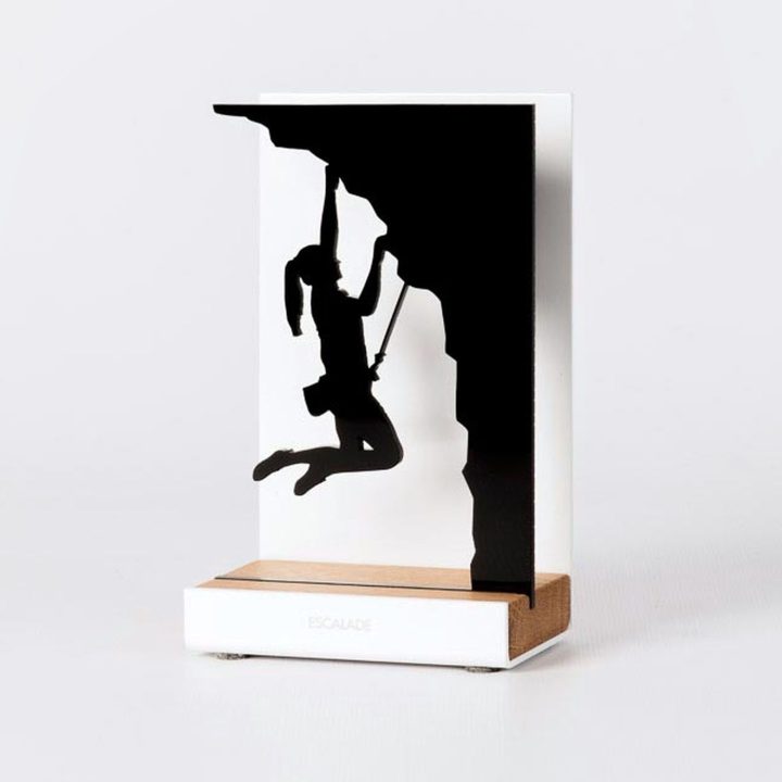 Figure "Climbing · Woman climber on an overhang", angled view showing its oak base