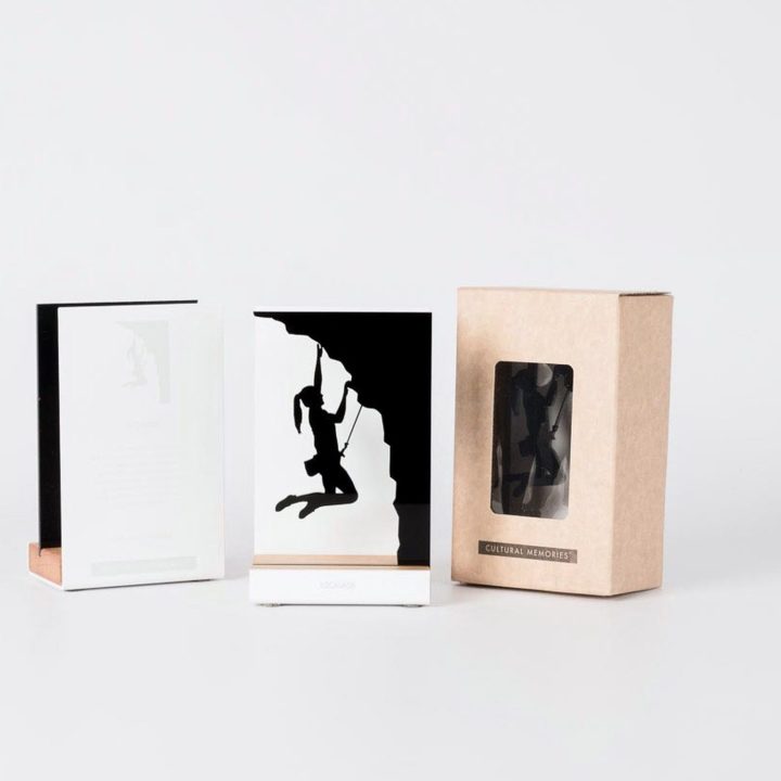 Figure "Climbing · Woman climber on an overhang" next to its sleeve and its gift box