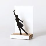 Figure "Figure skating · Ina Bauer with back arch", angled view showing its oak base