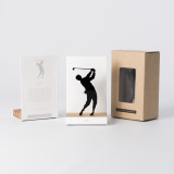 Figure "Golf · Swing classique en knickers" à côté de son coffret et de sa boîte cadeau